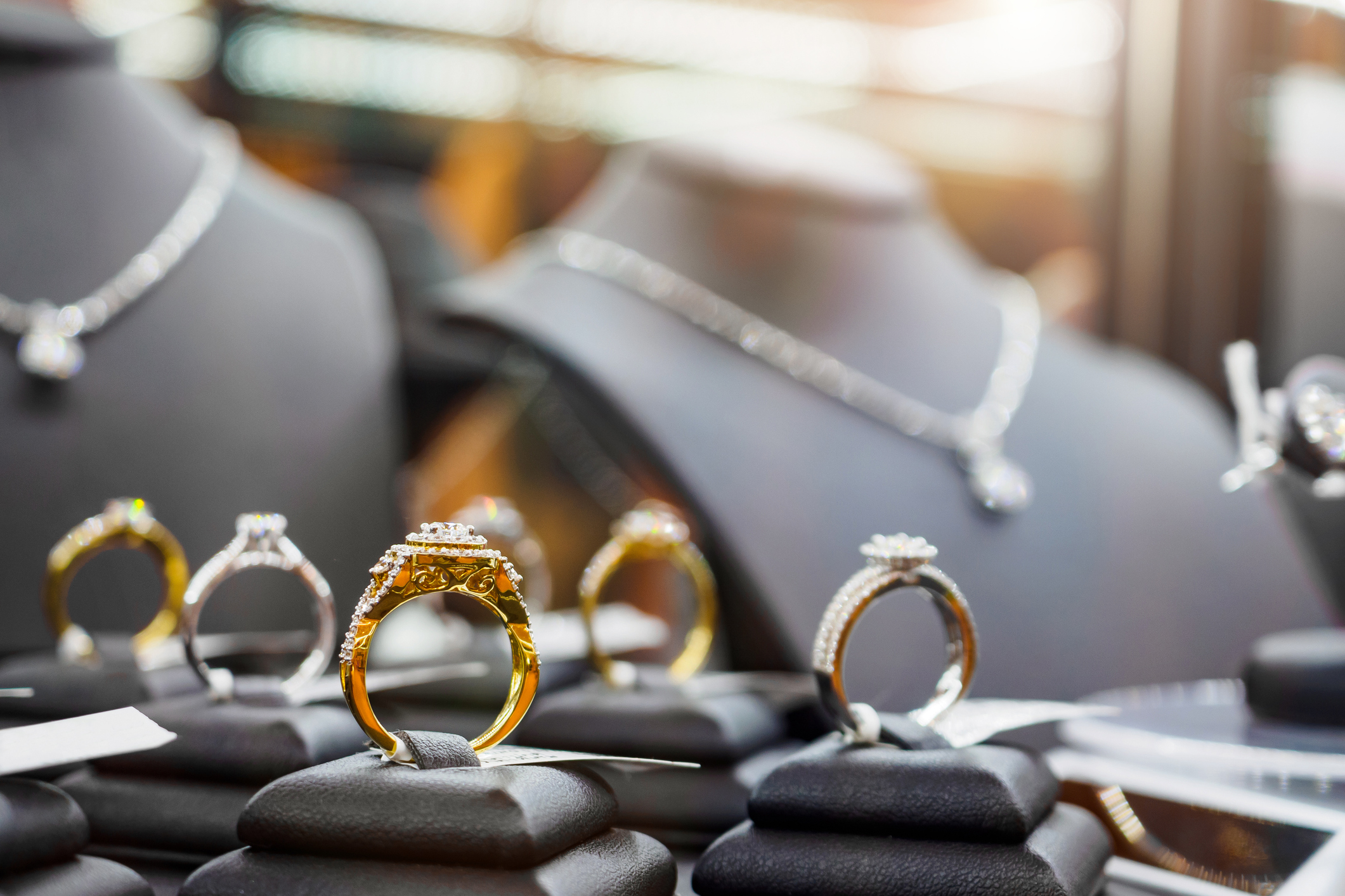 Gold jewelry diamond rings show in luxury retail store window display showcase Gold jewelry diamond rings show in luxury retail store window display showcase
